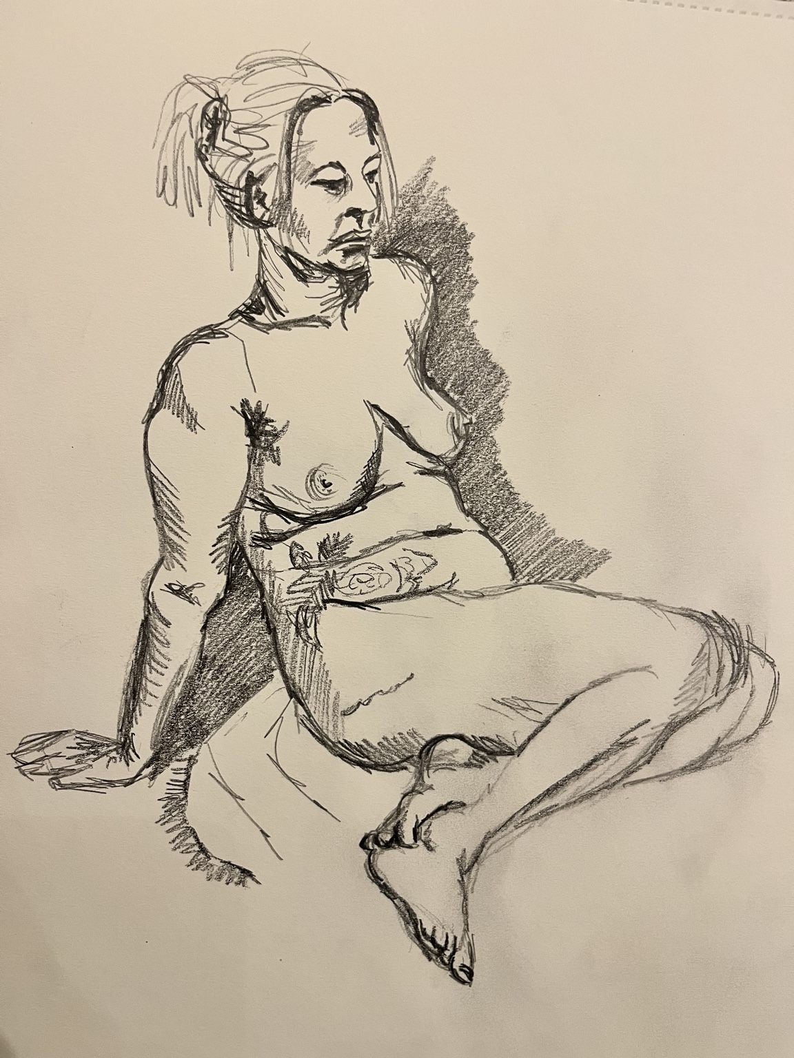 An expressive pencil life drawing of a seated figure